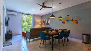 a dining room with a table and chairs at Riviera Home - New 2BR Condo w. big Pool & Jacuzzi in Playa del Carmen