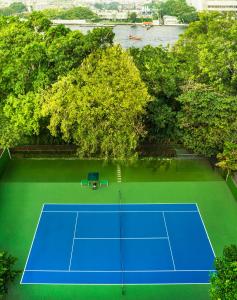 een uitzicht op een tennisbaan met bomen bij Royal Orchid Sheraton Hotel and Towers in Bangkok