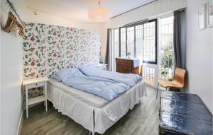 a bedroom with a bed and a desk and a window at Awesome Apartment In Sete With Wifi in Sète