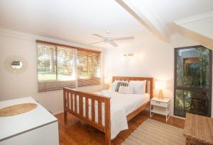 a bedroom with a bed and a window at 20 Yarrong Road Close to Cylinder Beach in Point Lookout