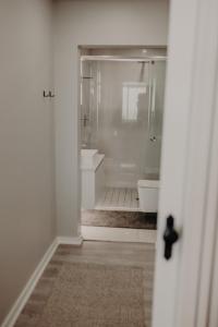 a white bathroom with a shower and a toilet at View @ The Bay Apartments 9 in Mossel Bay