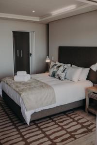 a bedroom with a large bed in a room at View @ The Bay Apartments 9 in Mossel Bay