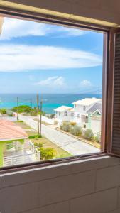 a view of the ocean from a window at Da-Vis By The Ocean in Saint Philip