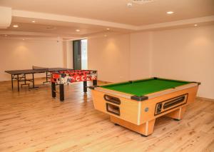 a room with a pool table and a ping pong table at Elegant One Bedroom in Westlands in Nairobi