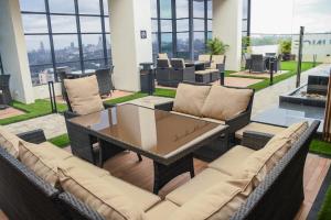 a patio with a table and chairs and windows at Elegant One Bedroom in Westlands in Nairobi