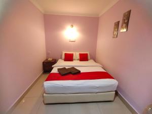 A bed or beds in a room at HOTEL PANTAI VIEW