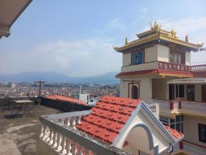 a building with a clock tower on top of a city at Bodhi Apartment hotel in Baudhatinchule