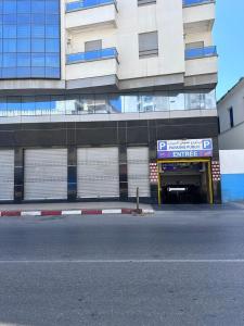 a parking garage in front of a building at Abraj Dubai Larache in Larache