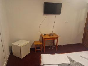 a room with a table and a television on the wall at Vila Ioana & Mirel in Eforie Sud