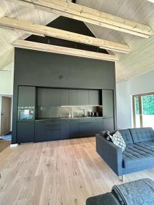 a living room with a blue couch and a kitchen at Dom w Marczowie in Prezezdziedza +21 photos