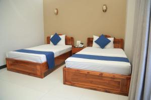 SP Tourist Hotel Jaffna客房内的一张或多张床位