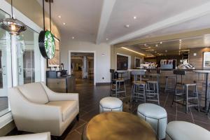 a bar in a restaurant with stools and a counter at Cedar Point Hotel Breakers in Sandusky