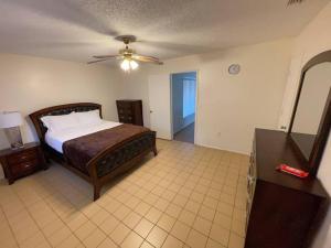 a bedroom with a bed and a dresser and a mirror at Lakeside retreat - 3 Bedroom, 2 Bathroom house by the lake in Lakeland