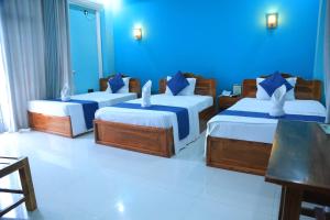 SP Tourist Hotel Jaffna客房内的一张或多张床位
