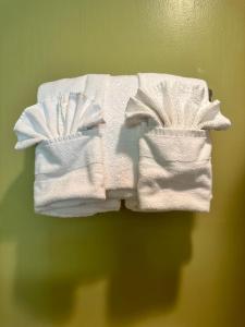 a stack of white towels hanging on a wall at Super 8 by Wyndham Eau Claire WI in Eau Claire