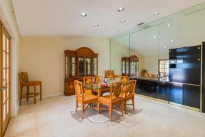 a dining room with a table and chairs and a kitchen at The Lakeview Retreat! So Much Room for Activities in Lauderhill