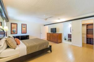 a bedroom with a bed and a flat screen tv at The Lakeview Retreat! So Much Room for Activities in Lauderhill
