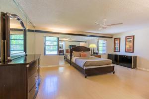 a bedroom with a bed and a dresser in it at The Lakeview Retreat! So Much Room for Activities in Lauderhill