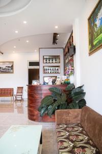 a living room with a couch and a bar at Sunrise Valley Dalat Hotel in Da Lat