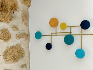 a wall with colorful wall hooks on a wall at Casa de Partida in Covilhã