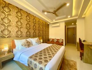 a bedroom with a large bed and a desk at Arogyadham Retreat in Rishīkesh