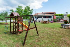 a playground with a slide in a yard at Casa Polari in Rovinj