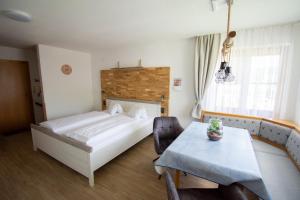 a hotel room with a bed and a table and a tableablish at Haus Kristina in Riezlern