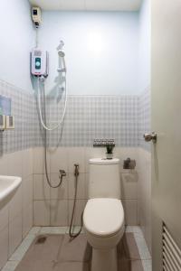 a bathroom with a toilet and a shower at TERRA: Grove area, 2 min walk to UPLB Gate in Los Baños