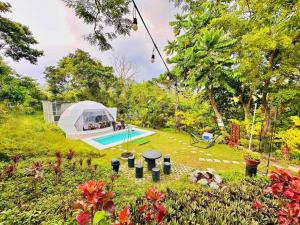 a backyard with a tent and a swimming pool at Shanti Wellness Sanctuary in Lemery