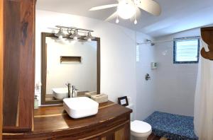a bathroom with a sink and a mirror at Sea Dreams Hotel in Caye Caulker +139 photos