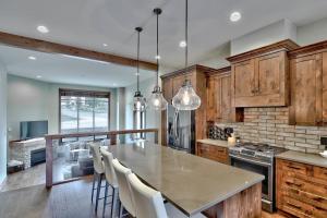 a large kitchen with a table and chairs in it at Village Walk #21 By Bear Country in Sun Peaks