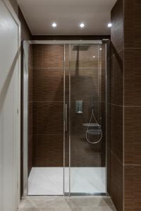 a shower with a glass door in a bathroom at La casa del Vescovo in Imola