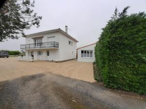a large white house with a large driveway at Mini Loft in Saintes