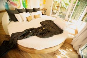 a bedroom with a bed with a dress on it at SOWK Resort in Baan Khai