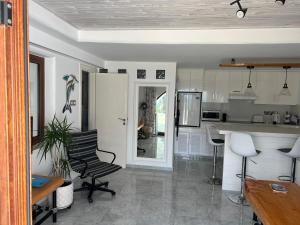 a kitchen with a table and chairs in a room at Pissouri Beach Front Apartments in Pissouri