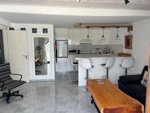 a living room with a table and a kitchen at Pissouri Beach Front Apartments in Pissouri