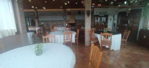 a dining room with white tables and chairs at Consoli Crispino in Francolise
