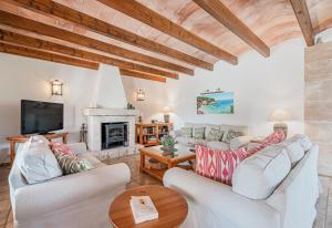 a living room with two white couches and a fireplace at Casa Verde in Sa Pobla