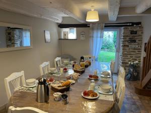a long table with chairs and food on it at Le couvent de Jouels in Sauveterre-de-Rouergue +24 photos