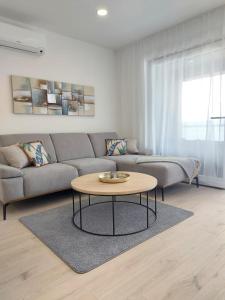 a living room with a couch and a coffee table at Villa Crystal Aenona in Nin