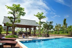 a resort with a swimming pool and a pavilion at Haikou Marriott Hotel in Haikou