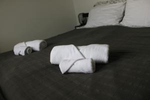 two rolls of towels sitting on top of a bed at Mediterranean Vista in Dubrovnik