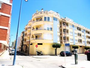 a large yellow building on a city street at Mediterraneo LEK in Peñíscola