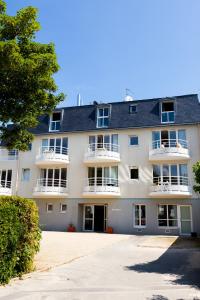 a large white building with a lot of windows at Village Vacances 3* Ternélia Les Résidences d'Armor in Douarnenez