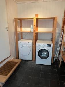 a laundry room with a washing machine and a washer at Large & Cozy Stavanger Apt in Stavanger