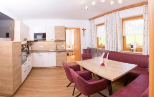 a kitchen and dining room with a table and chairs at Lochgrubgut in Altenmarkt im Pongau