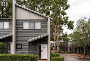 a house with black and white siding at At Forest Stay in Margaret River Town