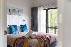 a bedroom with a bed with a laptop on it at At Forest Stay in Margaret River Town