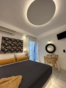 a bedroom with a large bed with a large ceiling at Sea View Apartments & Studios in Agia Anna Naxos