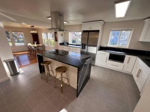 a kitchen with white cabinets and a black counter top at The Alfred, Downtown Chehalis in Chehalis